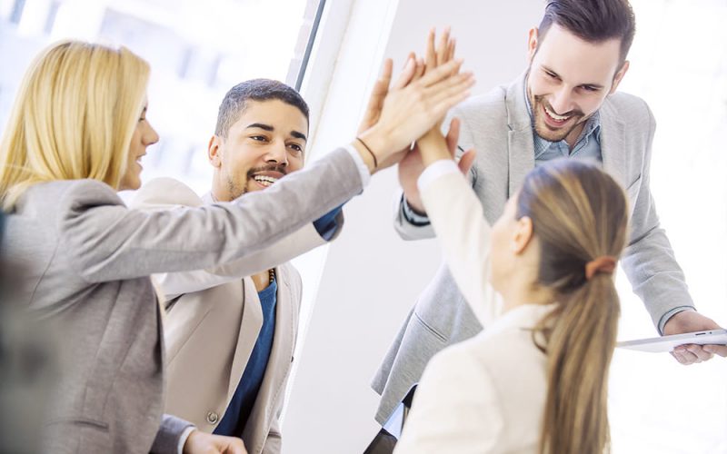 Young business people joining hands together for success